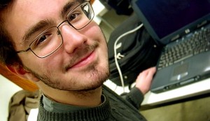 happy-man-on-computer Man on laptop working on his internet marketing business